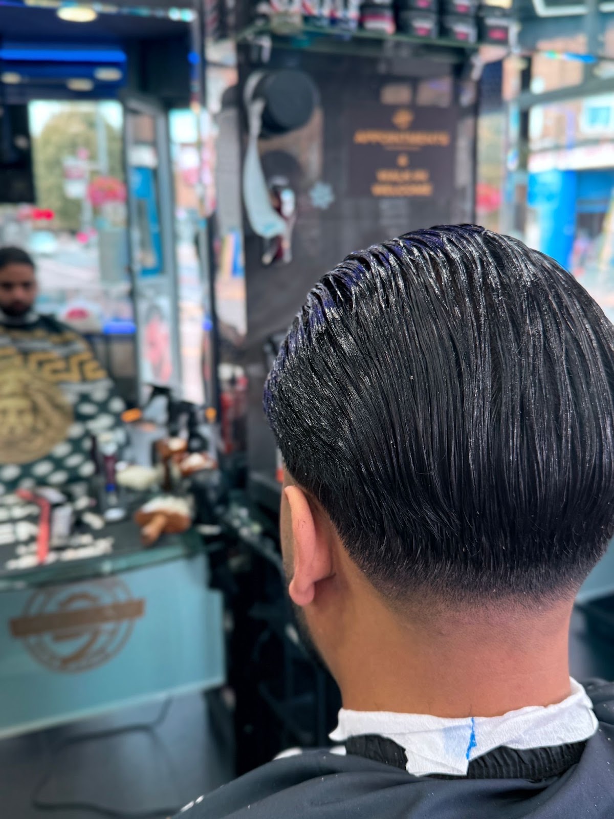 Back of a finished slick-back cut with a tapered neckline